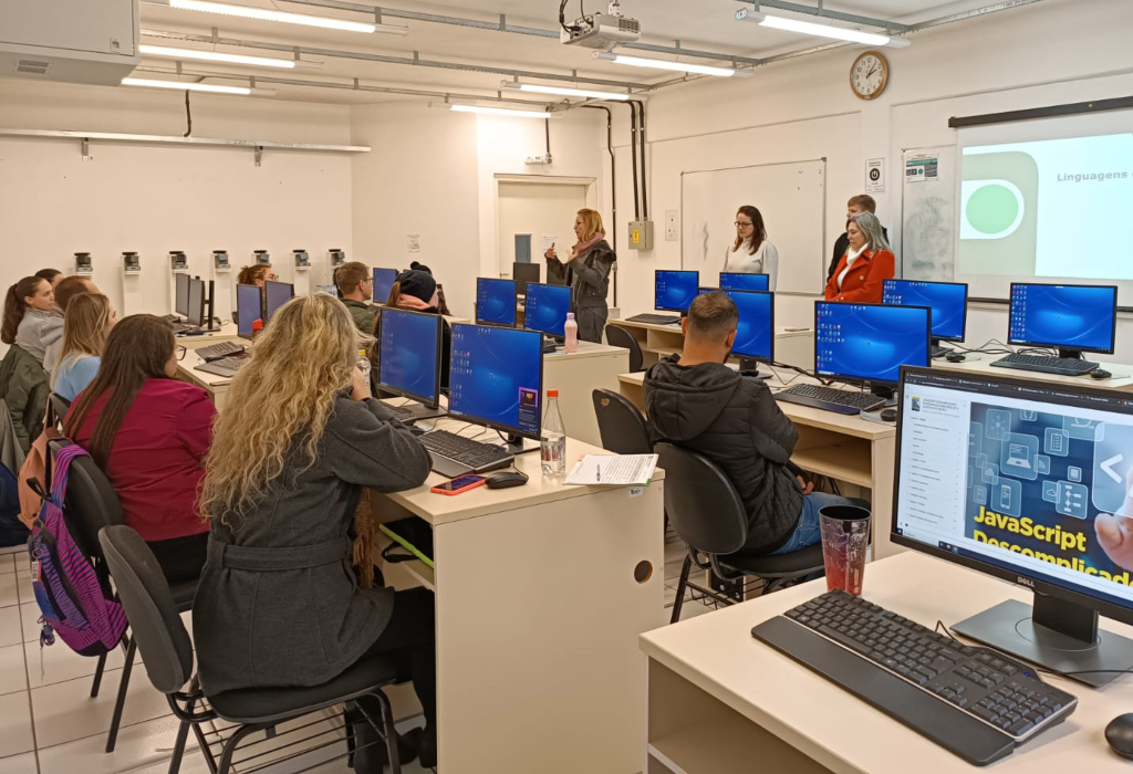 Professores participam de capacitação em sala com computadores